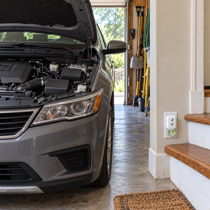 The car in the garage with its hood up and a clean engine bay, MintKeep plugged in by the steps.
