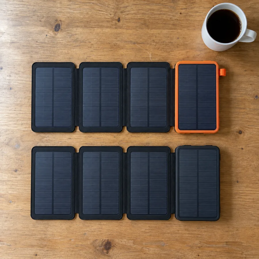 Seen from above on a kitchen table: the TerraCell Max with its orange body on top, the black TerraCell you ordered below, the same size and shape