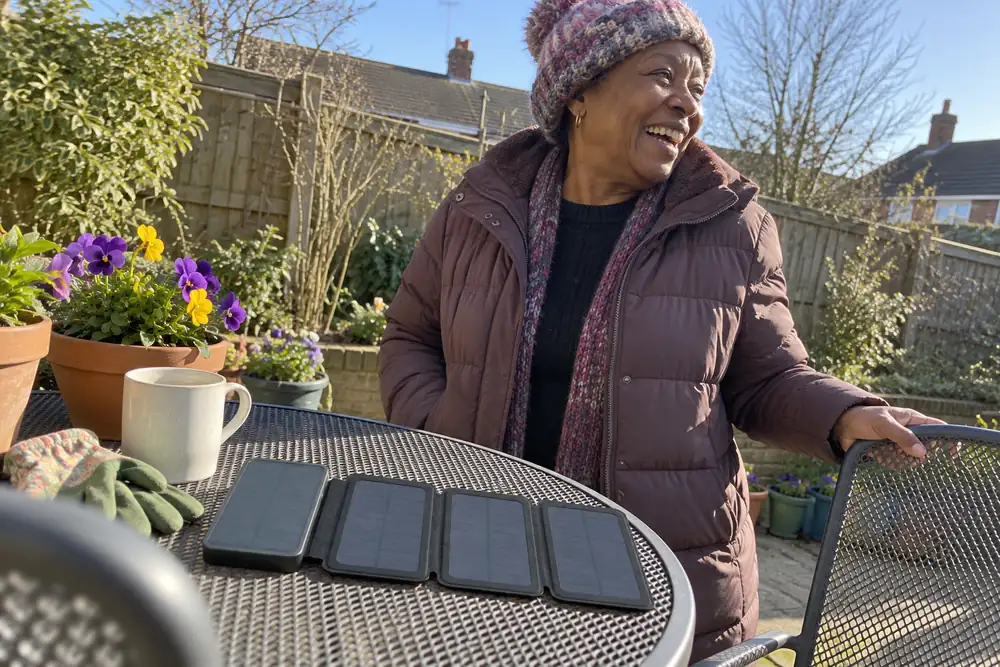 Bernice laughing in her garden, her TerraCell open on the table