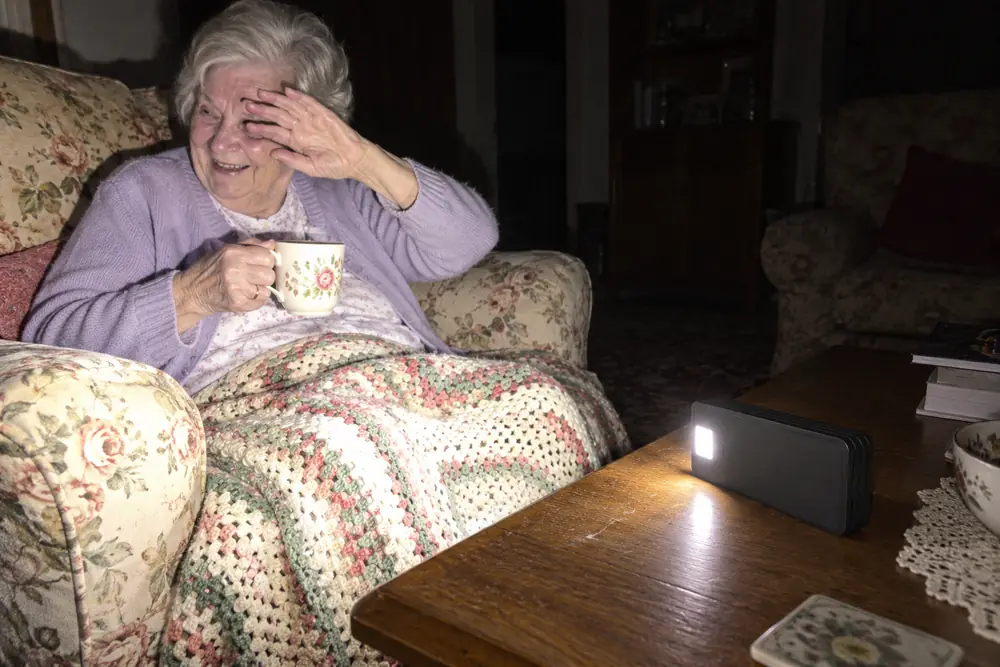 Shirley's mum laughing on her sofa, TerraCell's light on beside her