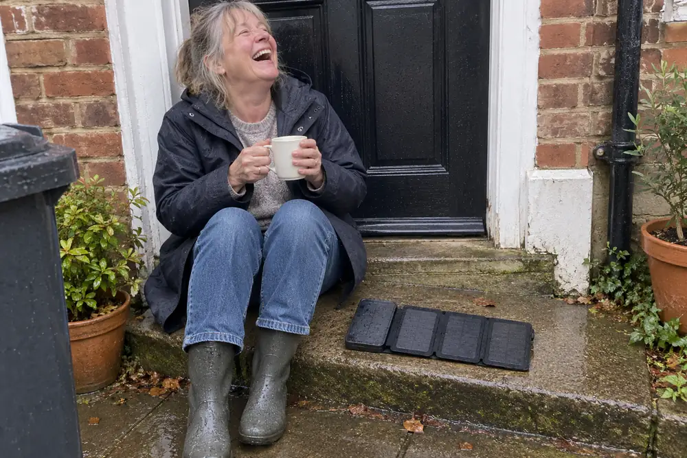 Annette laughing on her front step, her TerraCell open beside her