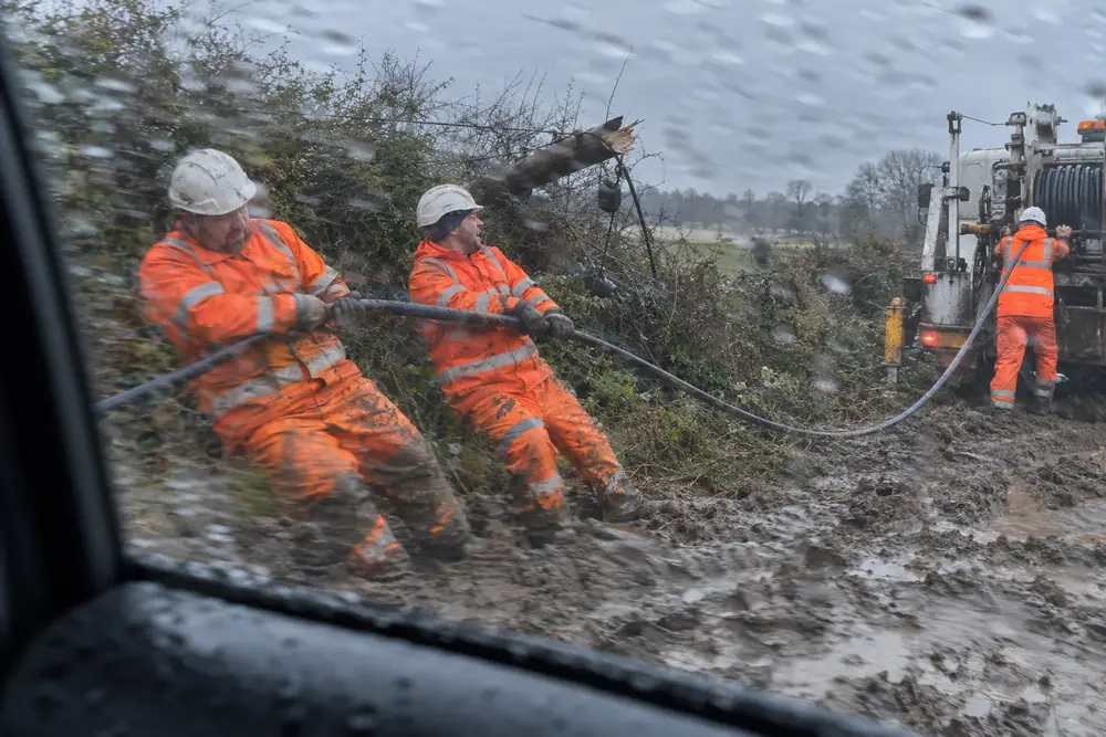 A power crew hauling new cable after the storm