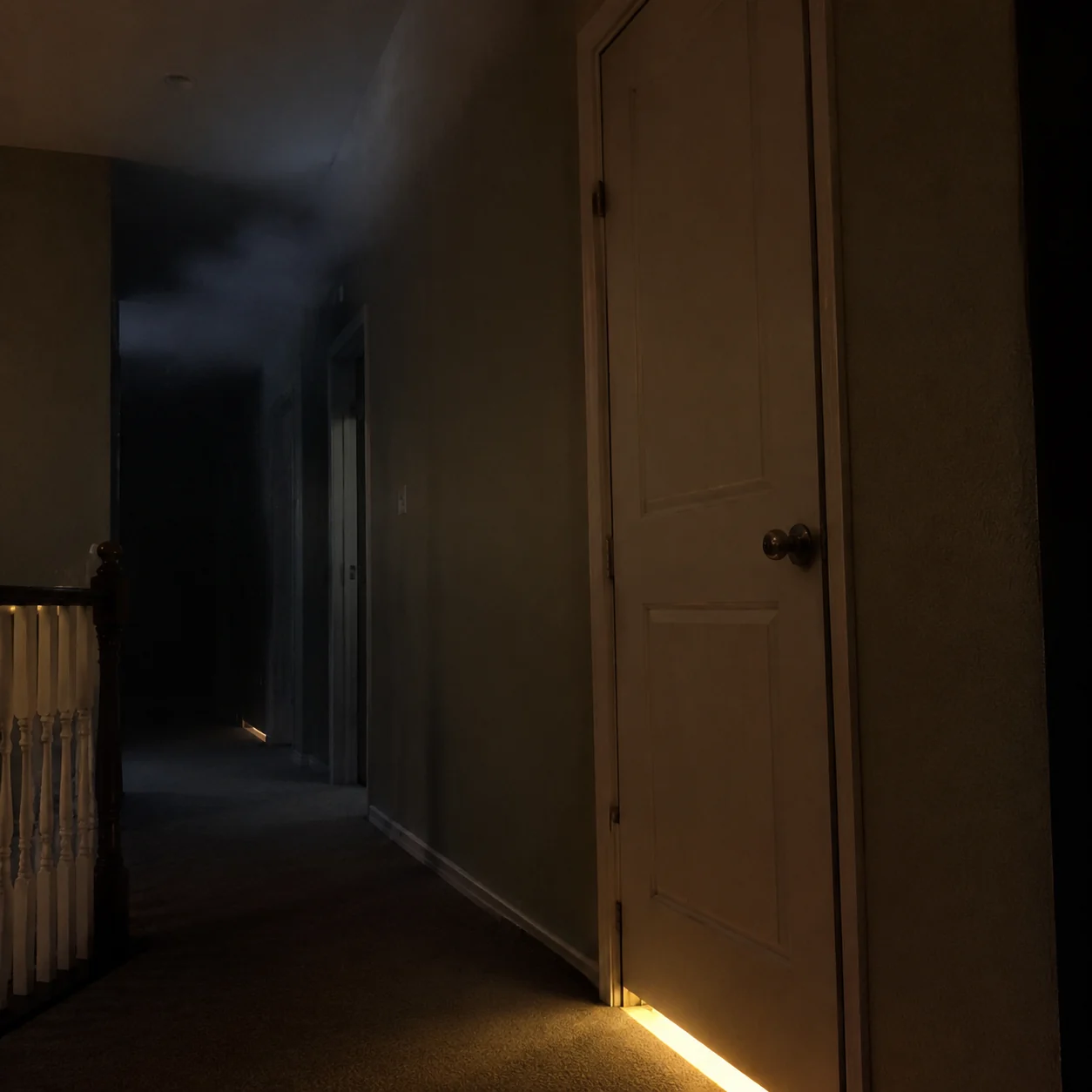 Night smoke near closed bedroom door