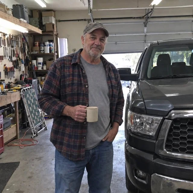 Robert K. in his garage beside his pickup